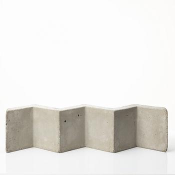 A mixed lot comprising a pair of limestone bookends, a bookshelf and two plates in concrete.