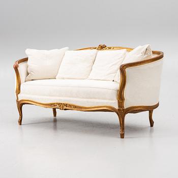 A Louis XV-style sofa, early 20th century.