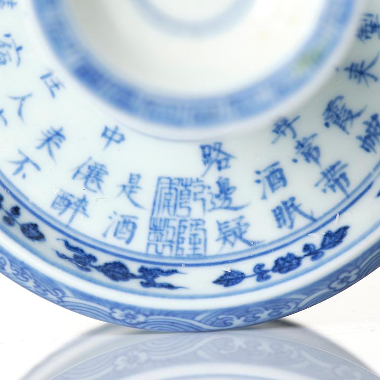 A pair of blue and white pricket candle sticks, with a poem, Qing dynasty with a Qianlong mark and of the period.