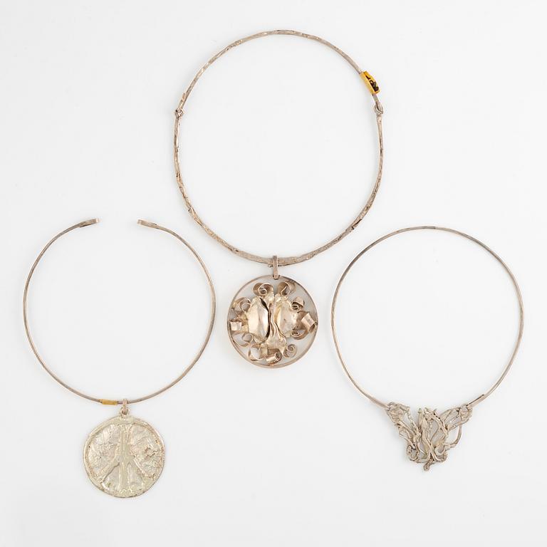 Lars Arby, three neck rings with pendants, silver, Gothenburg including 1977, 1978, and 1982.