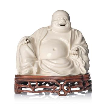 955. A blanc de chine figure of Budai, Qing dynasty, 18/19th century.