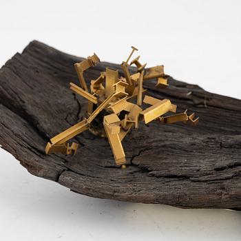 Arne Jones, sculpture, brass on driftwood, signed on label by the estate.