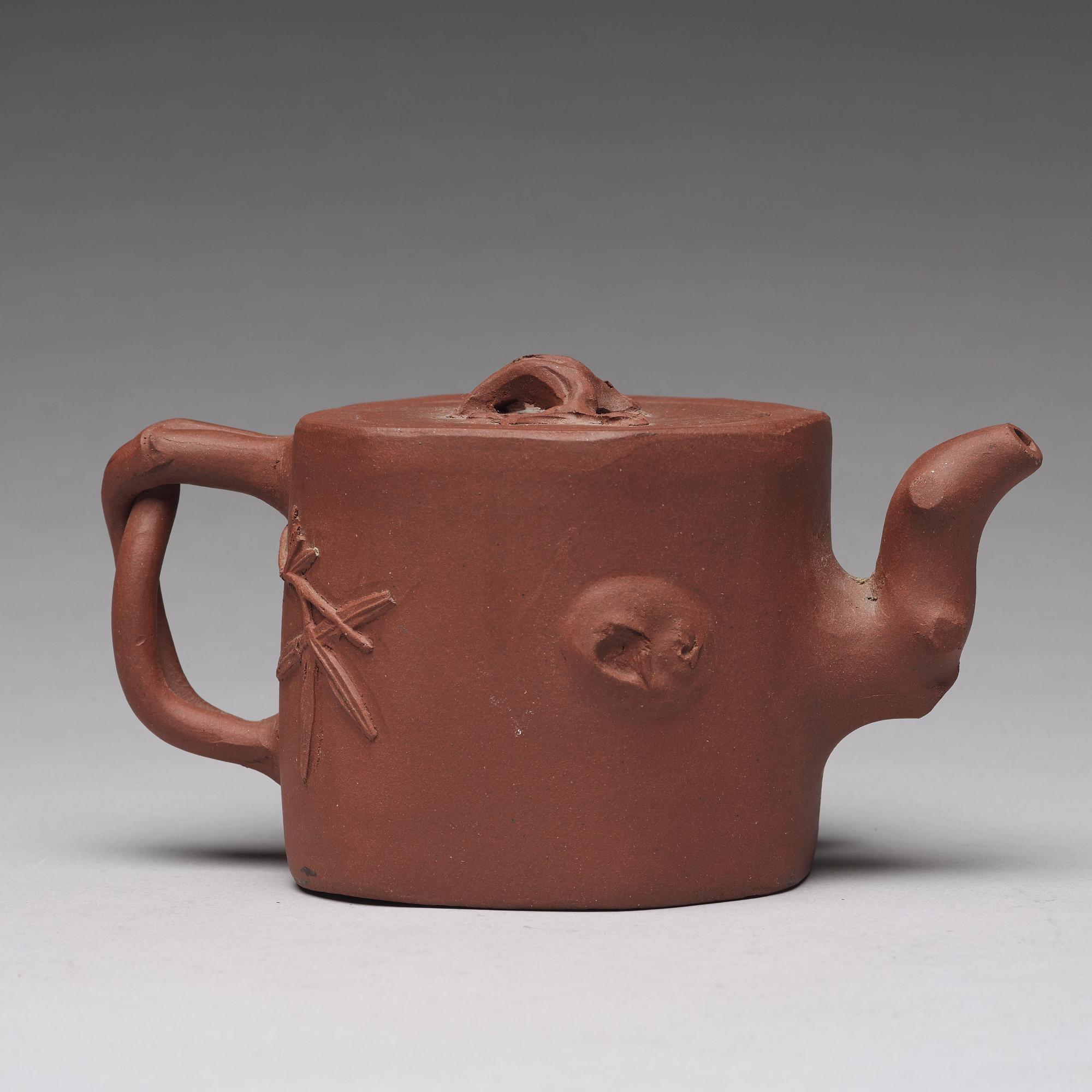 A Yixing teapot with cover, Qing dynasty, 19th Century. With sealmark to base.