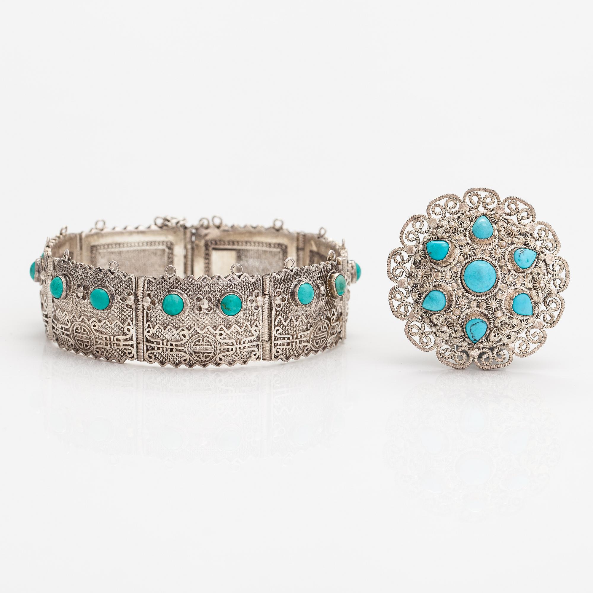 A silver bracelet and ring with turquoises. China.