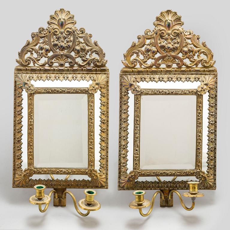 An early 20th Century pair of baroque style mirror sconses.