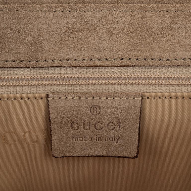 Gucci, a suede handbag.