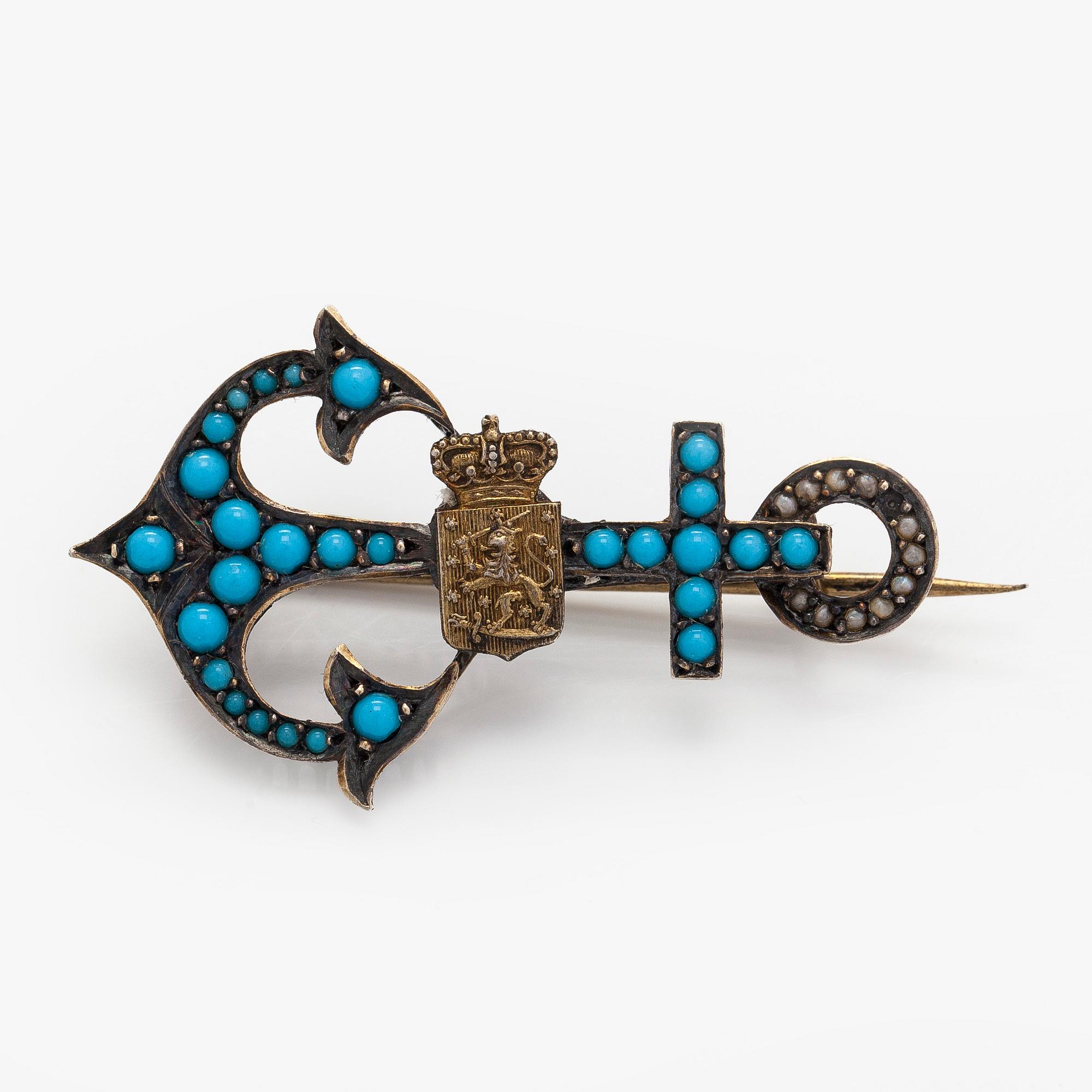 Rintakoru, turkoosit, helmet, Suomen vaakuna, kullattu hopea, 1900-luvun alussa.