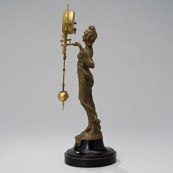 A 1930s Junghans swinger clock with girl sculpture.