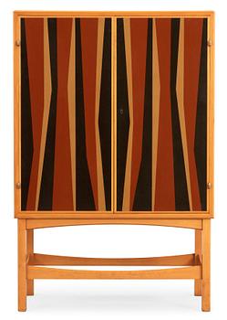 23. A Curt Blomberg mahogany cabinet, the doors, sides and top with painted panels, ca 1954.