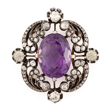 624. A brooch/part of a tiara with a faceted amethyst and old- and rose-cut diamonds.
