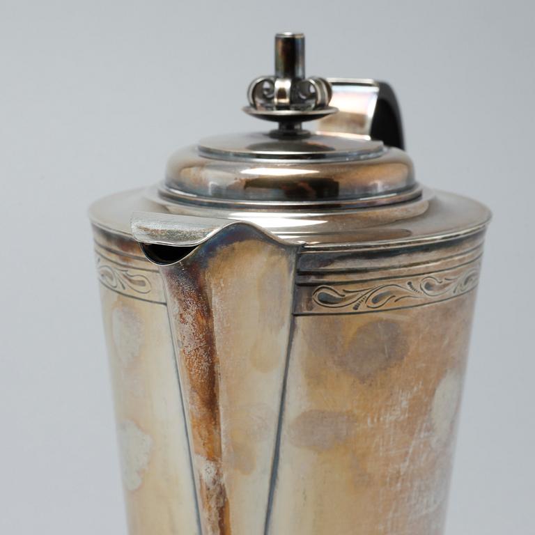 A silver coffee pot, sugar bowl and creamer by Thore Eldh for K&EC in Göteborg, 1949.