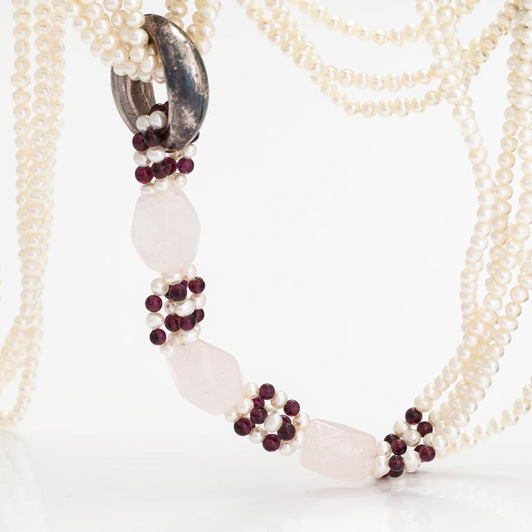 A sweet water, rose quartz, garnet and wood pearls collier with a Tiffany & co silver ring designed by Elsa Peretti.