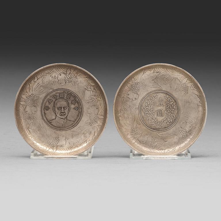 A set of two coasters with Chinese silver coins, 20th Century.