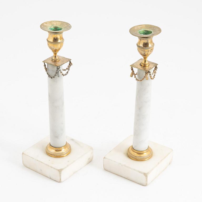 A pair of late Gustavian marble candlesticks, early 19th Century.