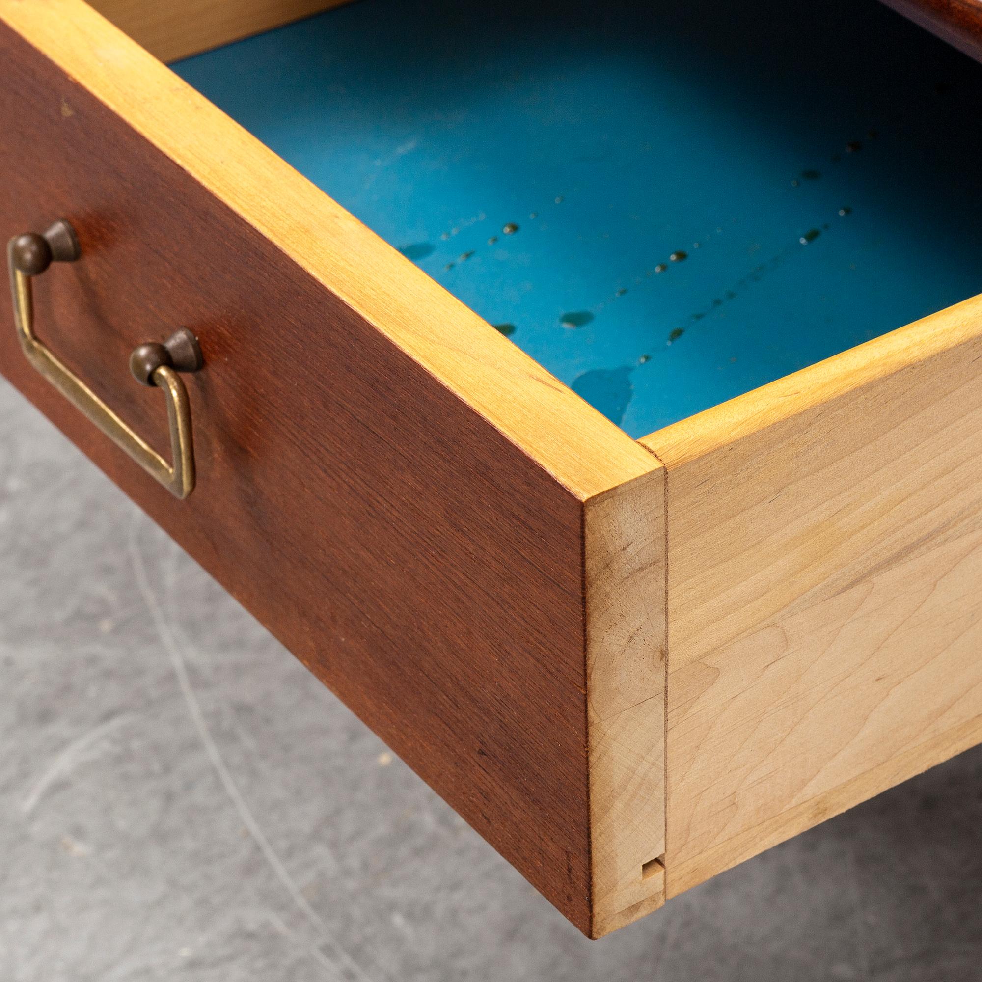 A pair of teak veneered bedside tables.