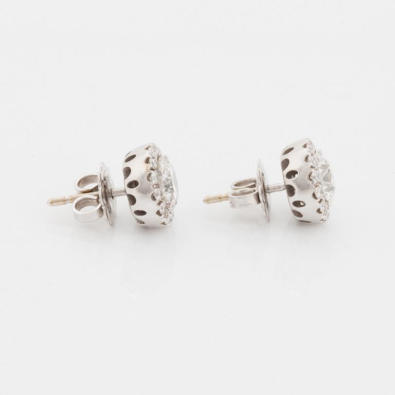 A pair of 18K white gold earrings.
