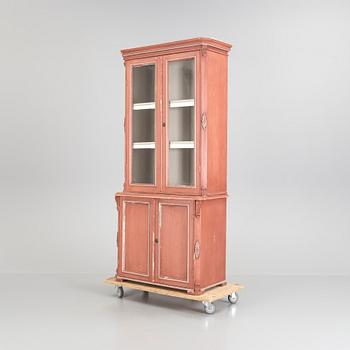 A pained late 19th century vitrine book cabinet in two sections.