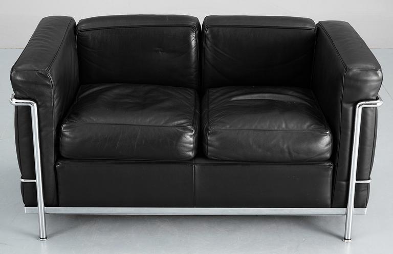 A Le Corbusier 'LC 2' two-seated black leather and chromed steel sofa, by Cassina, Italy.