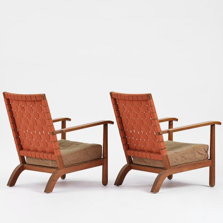 Axel Einar Hjorth, a pair of stained pine "Väddö" easy chairs, Nordiska Kompaniet, Sweden, 1930s-40s.