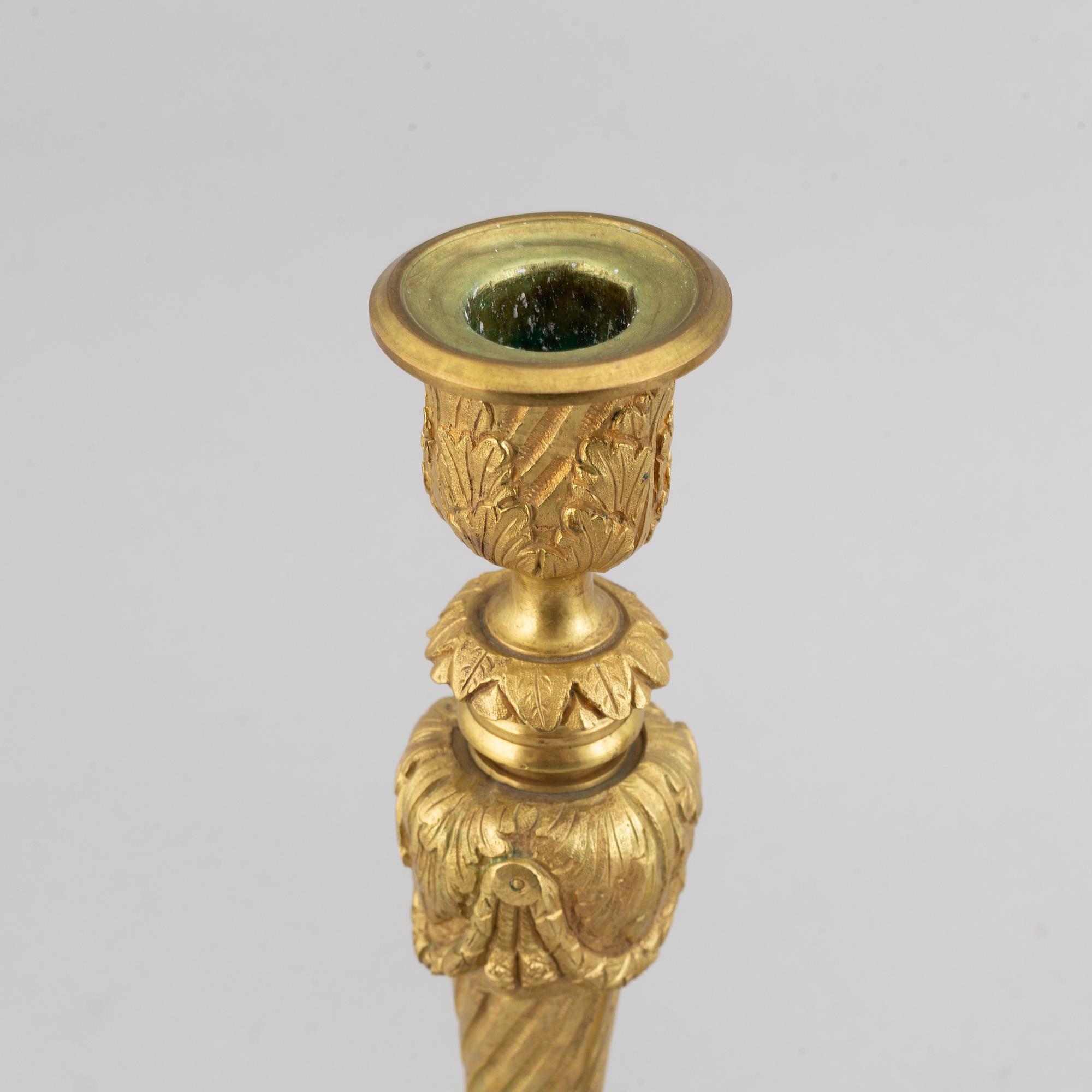 A pair of bronze Louis XV-style candlesticks, circa 1900.