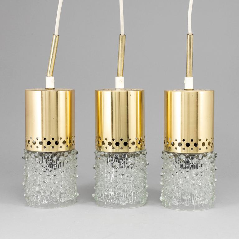 Three brass and glass pendant lights, 1960's.