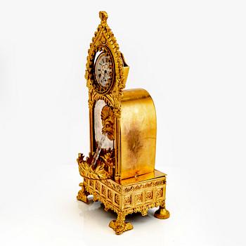 A mid 1800s gilded bronze pocket watch stand and pocket watch.