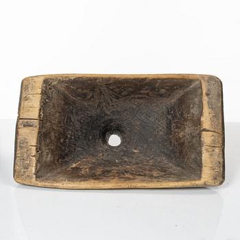 A Swedish carved wood milk funnel, dated 1687.