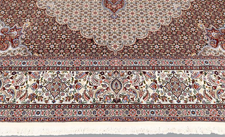 A part silk Moud carpet, approximately 350 x 252 cm.