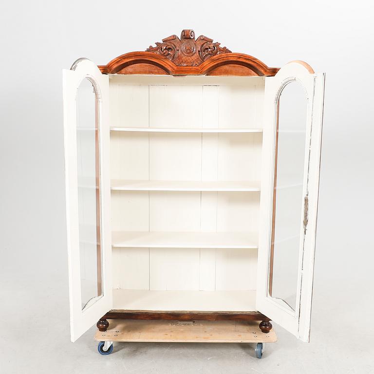 A walnut display cabinet around 1900.