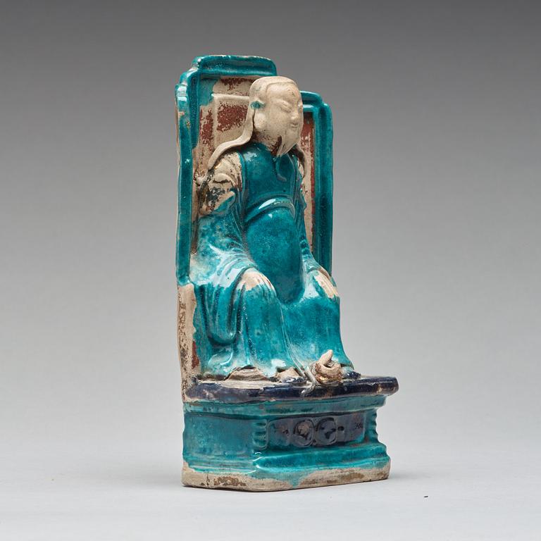 A turquoise and purple glazed figure of a dignitary, Qing dynasty, Kangxi (1662-1722).