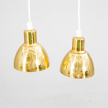 A pair of Hans-Agne Jakobsson brass ceiling pendants.