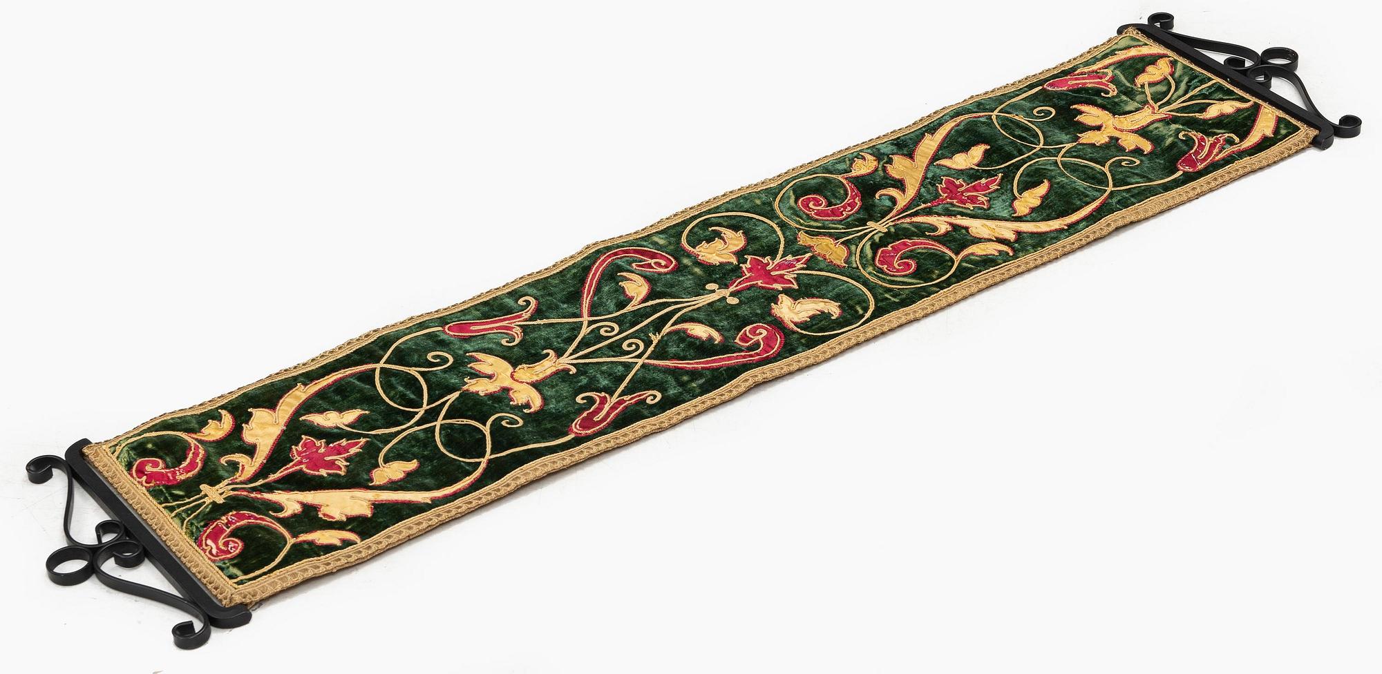 A 17th century Spanish embroidered velvet panel, c. 77 x 18.5 cm.