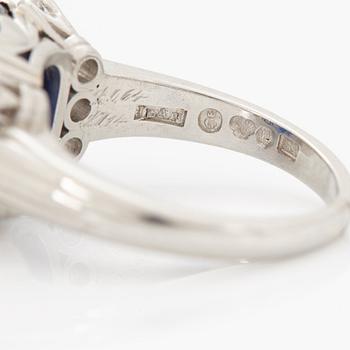 A RING set with a faceted sapphire.