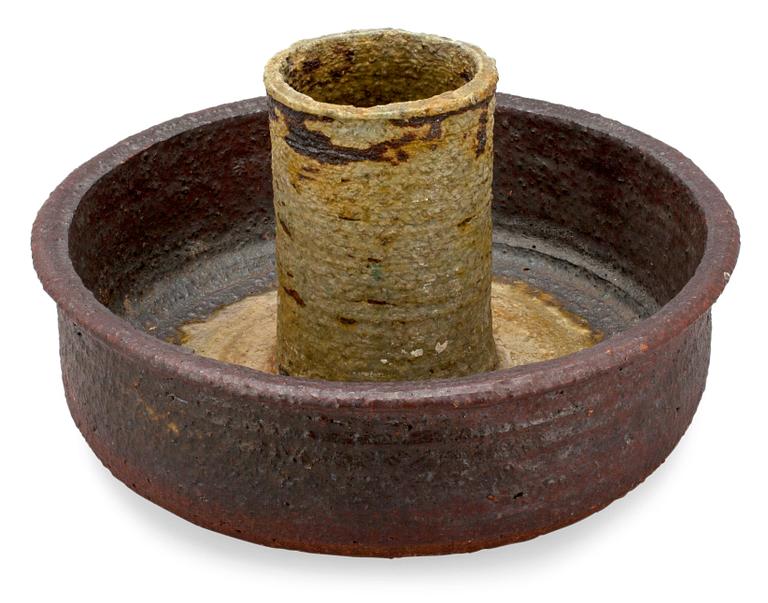 A CERAMIC CANDLESTICK.
