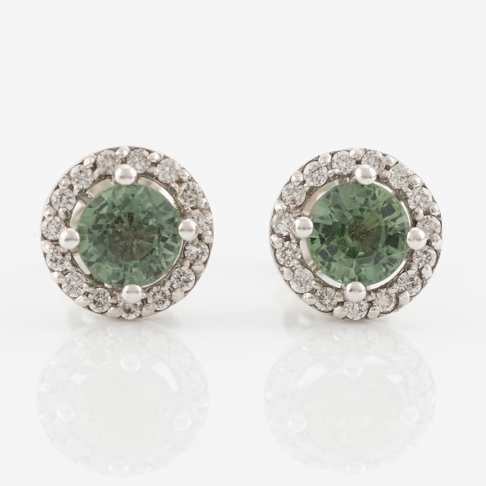 A pair of 18K gold earrings with green faceted sapphires and round brilliant-cut diamonds.
