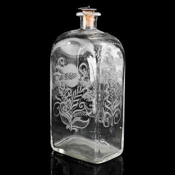 A glass bottle and three vodka glasses, 19th Century.