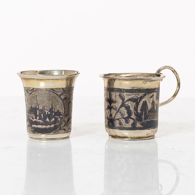 Two Russian parcel-gilt silver niello vodka cups, Moscow 1832 and 1845.