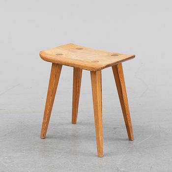 A pine stool by Carl Malmsten for Karl Andersson.