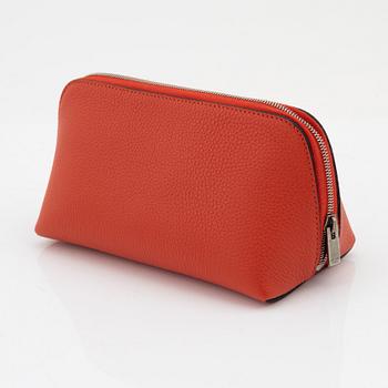 Céline, A cosmetic pouch in bright red leather.