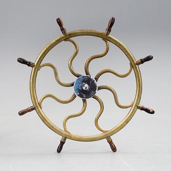 A ship steering wheel, about 1900.