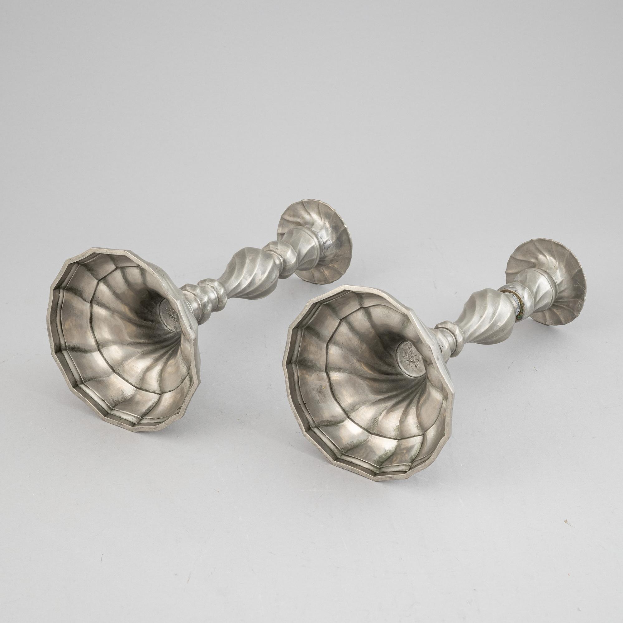 A pair of rococo style pewter candlesticks, 19th Century.