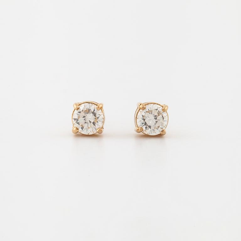 A pair of brilliant cut diamond earrings.