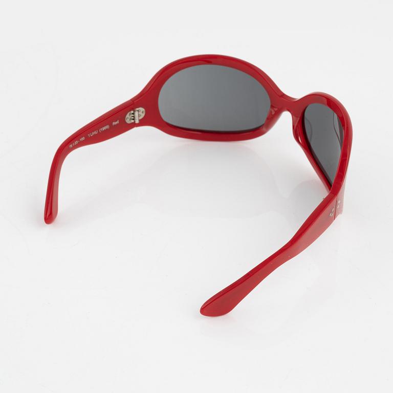 Oliver Goldsmith, a pair of red "Yuhu" sunglasses.