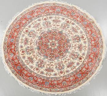 A Kashmar rug, part silk, diameter 245 cm.