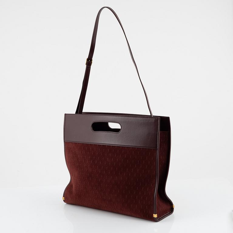 Yves Saint Laurent, a burgundy leather and suede handbag.