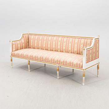 A painted and guilded late gustavian sofa from the 19th century.