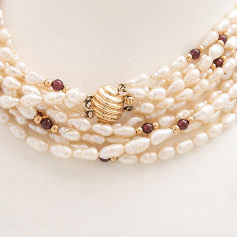 Multi-strand necklace with clasp and beads in 14K gold, cultured pearls, and garnet beads.