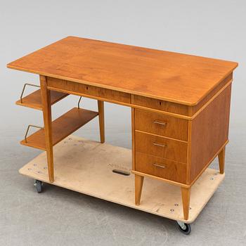 A teak veneered desk, 1950's.