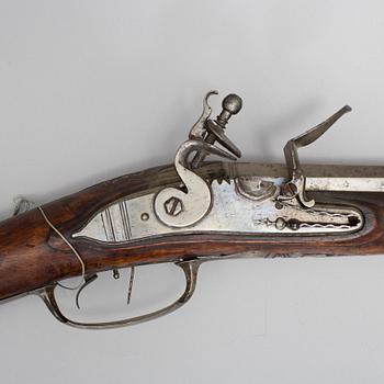 A 18th century flintlock rifle.