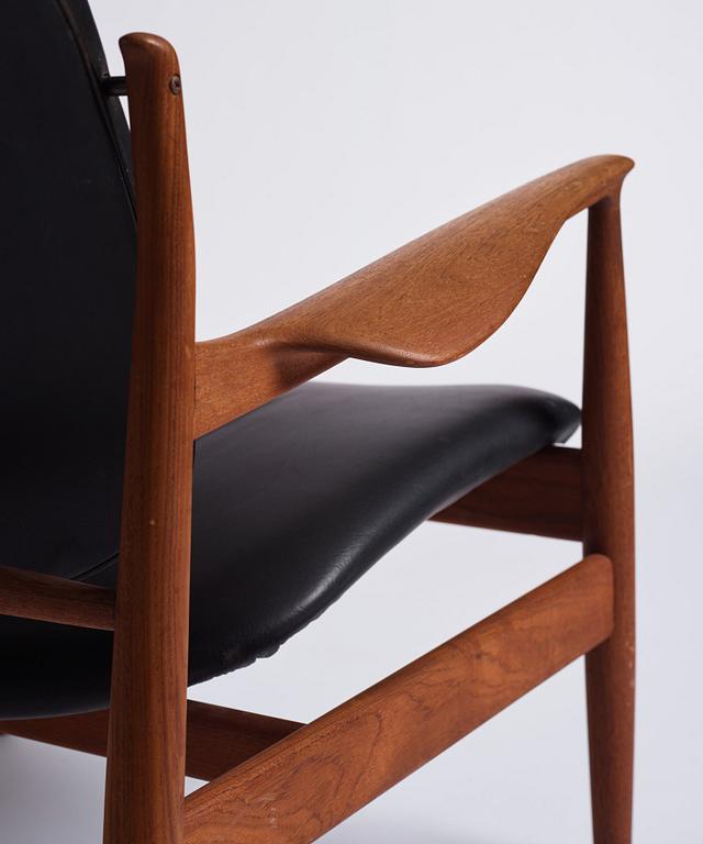 Finn Juhl, a teak and black leather 'model 136' easy chair, France & Daverkosen, Denmark 1950-60s.